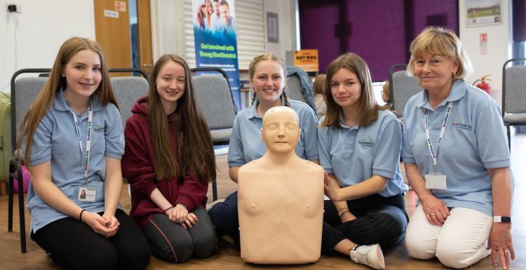 Young people performing CPR in class