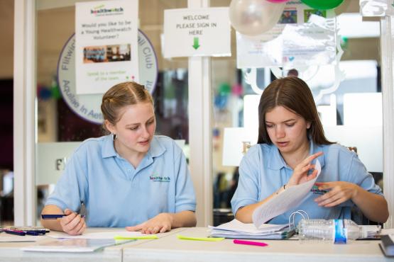 Two young girls sitting at a desk